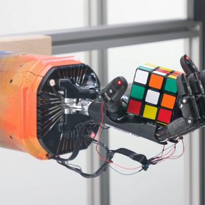 OpenAI's robot hand holding a Rubik's Cube